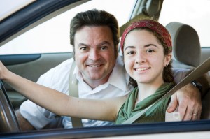Teen girl in car with father