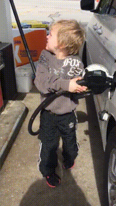 Kid pumping gas