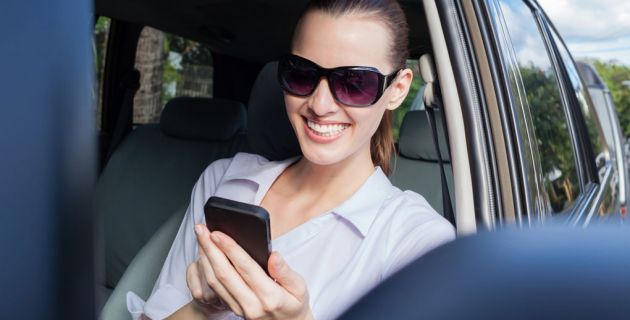Woman using phone in car.